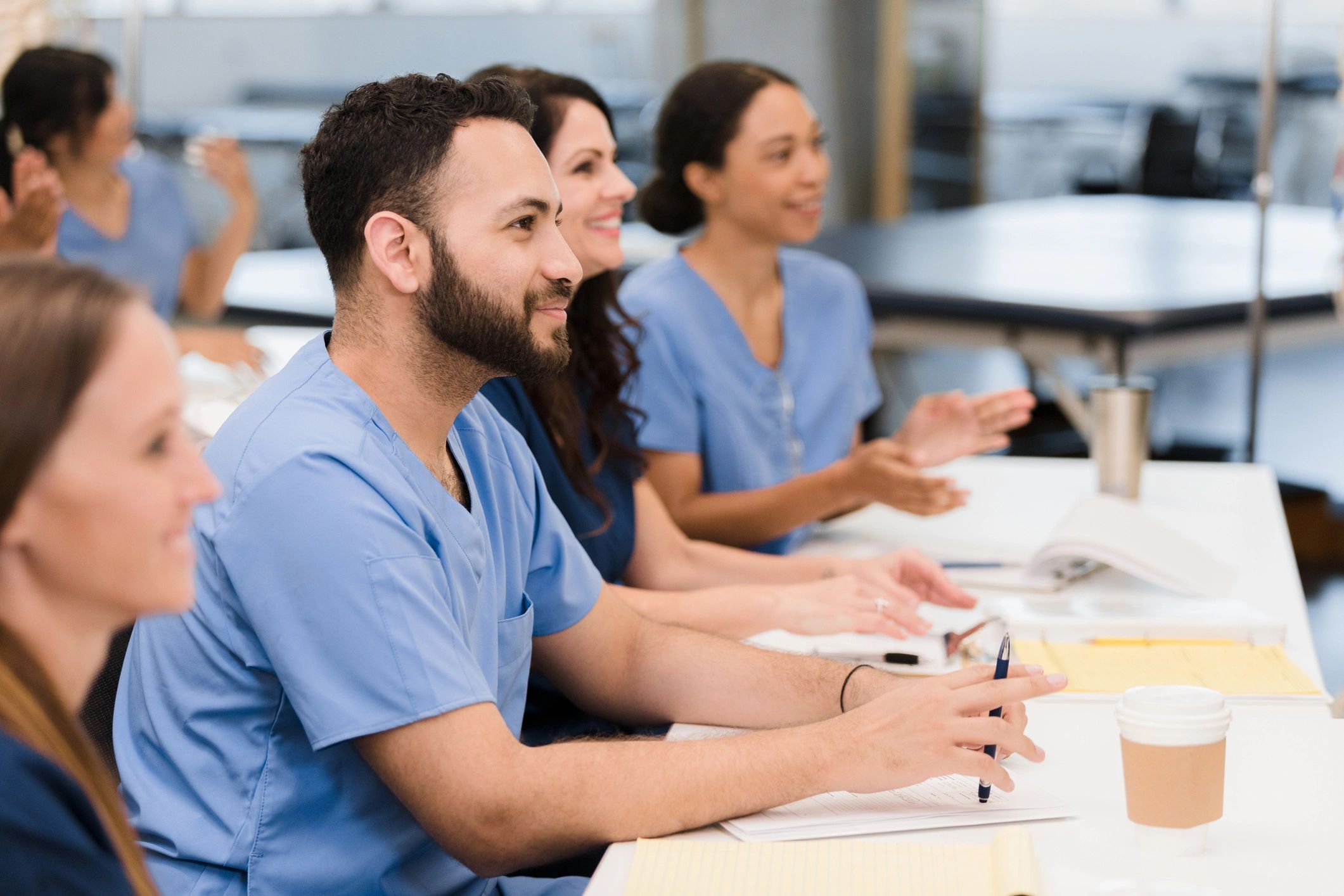 Allied health and healthcare professionals in a focused learning session